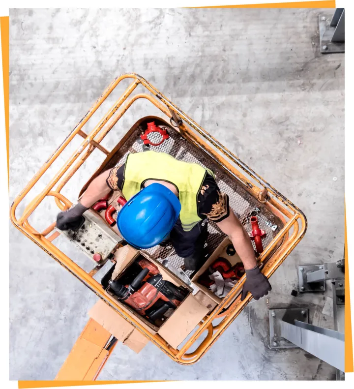 Worker operating an aerial lift from the platform