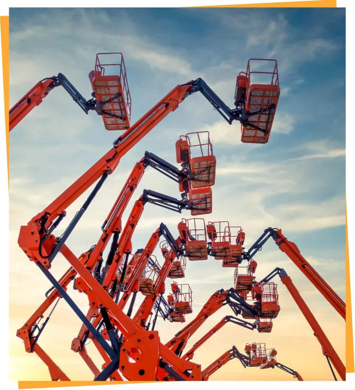 Several articulating boom lifts extended at height