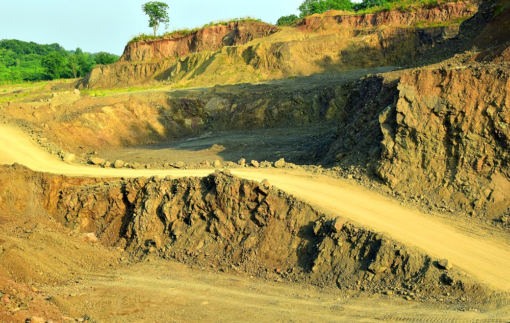 Dirt road winding through an excavation site