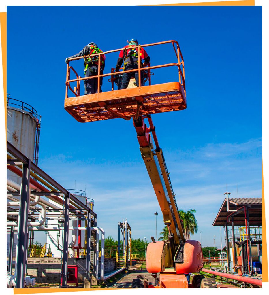 a man standing on top of a crane next to a building.