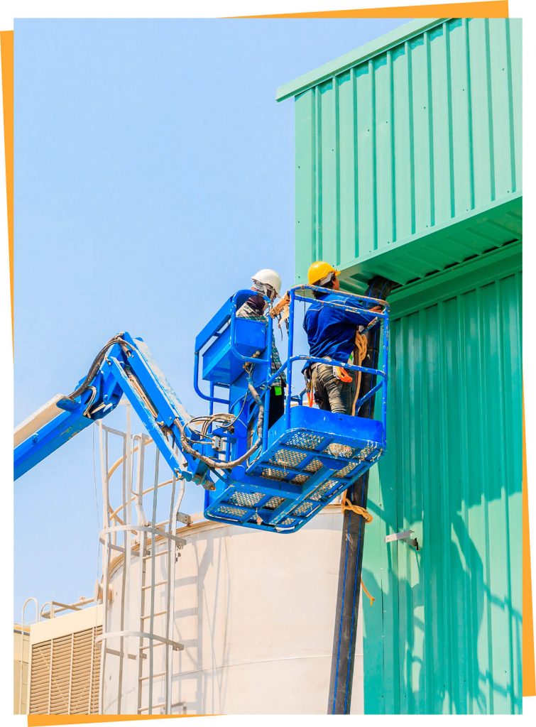 a man on a blue lift working on a building.